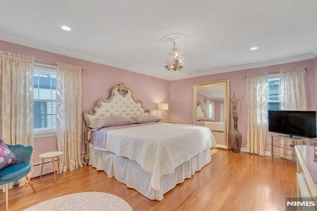 bedroom featuring a chandelier, a baseboard radiator, light hardwood / wood-style flooring, and ornamental molding