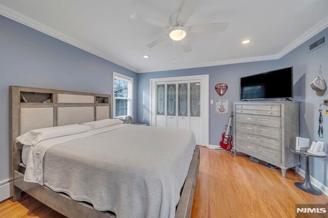 bedroom featuring hardwood / wood-style floors, ceiling fan, and ornamental molding