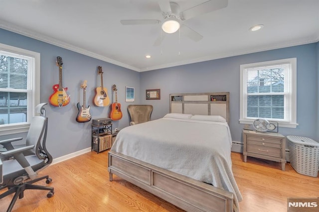 bedroom with ceiling fan, light wood-type flooring, ornamental molding, and a baseboard radiator