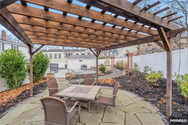 view of patio with a pergola and a shed