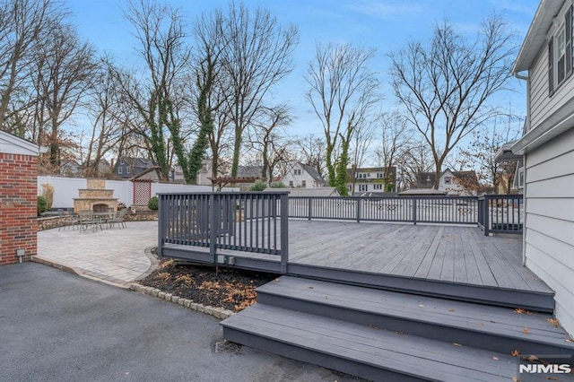 wooden deck featuring a patio area and an outdoor fireplace