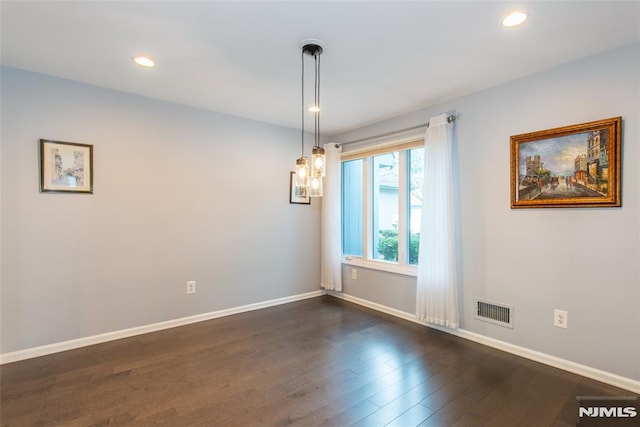 empty room featuring dark hardwood / wood-style floors