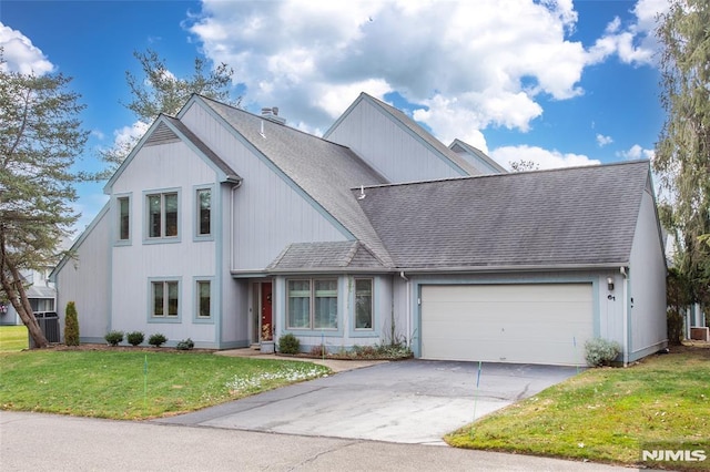 view of front of property with a front yard and a garage