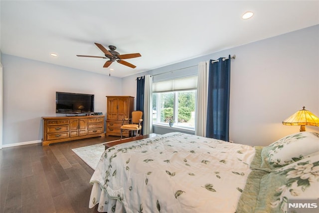 bedroom with ceiling fan and dark wood-type flooring