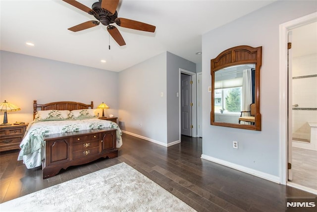 bedroom with ensuite bath, dark wood-type flooring, and ceiling fan