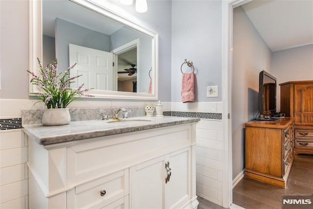 bathroom with ceiling fan, vanity, and hardwood / wood-style floors