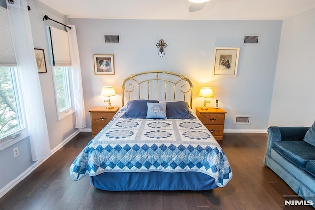 bedroom with ceiling fan and dark wood-type flooring