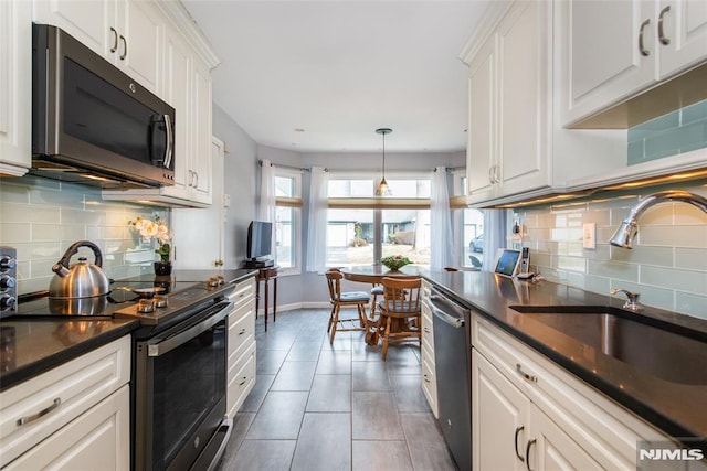 kitchen with stainless steel appliances and white cabinets