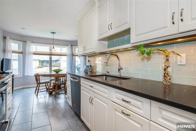 kitchen with sink, white cabinets, and appliances with stainless steel finishes