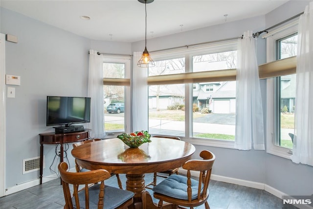 dining area featuring dark wood-type flooring