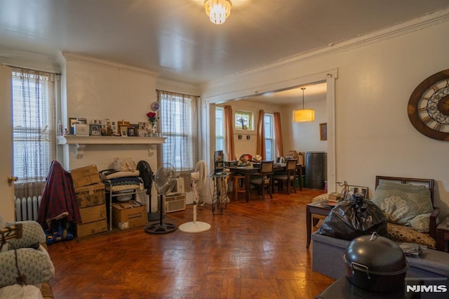 living room with crown molding and dark parquet floors