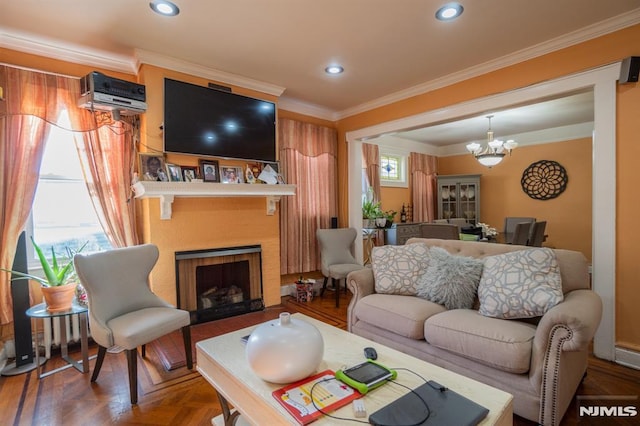 living room featuring parquet floors, crown molding, a wall mounted AC, and an inviting chandelier