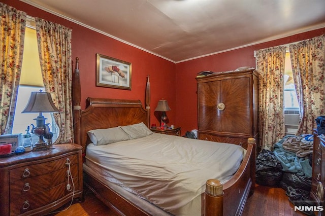 bedroom featuring hardwood / wood-style floors and ornamental molding