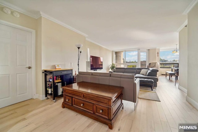 living room featuring light hardwood / wood-style floors, a wall of windows, and ornamental molding