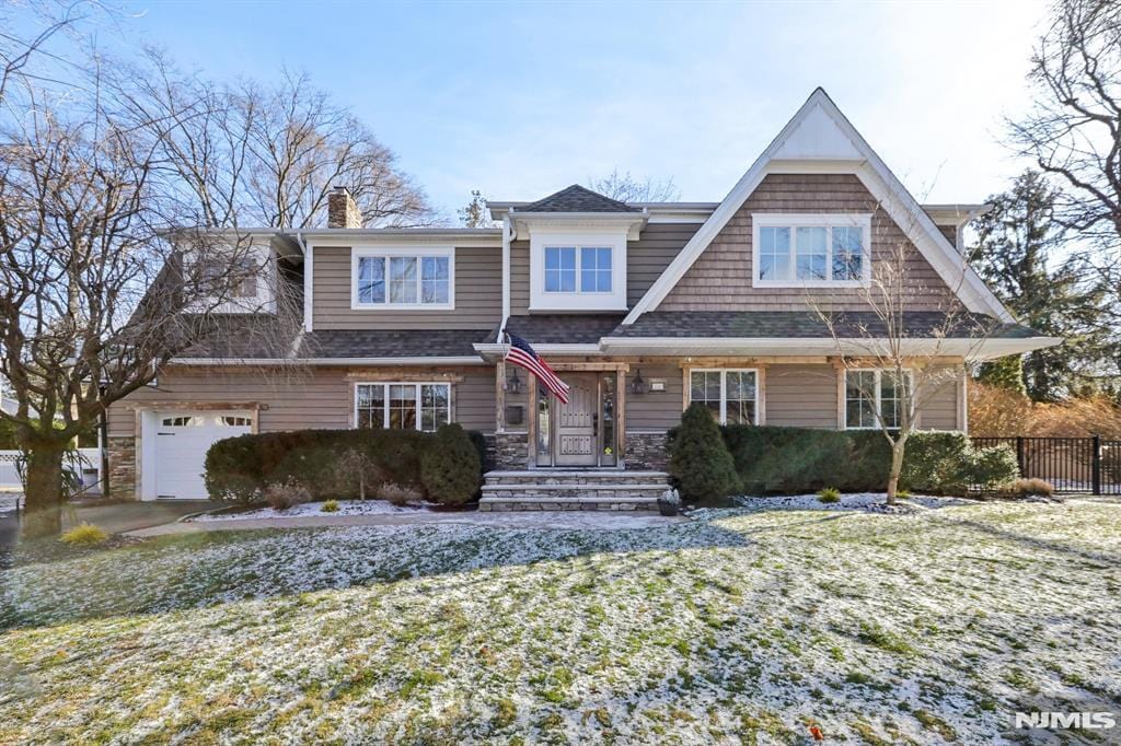 view of front of house with a garage and a front yard