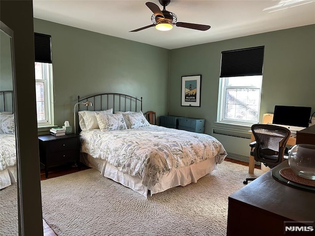 bedroom with hardwood / wood-style floors and ceiling fan