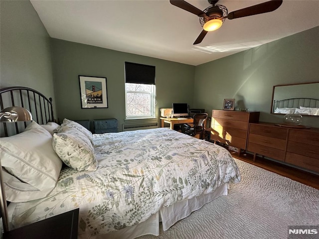 bedroom with hardwood / wood-style flooring and ceiling fan