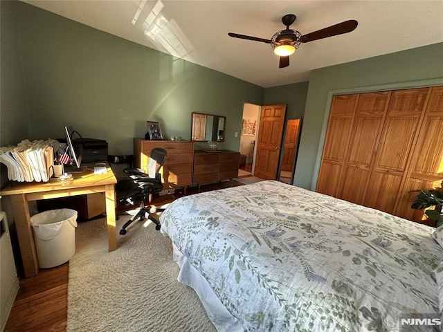 bedroom with ceiling fan and a closet