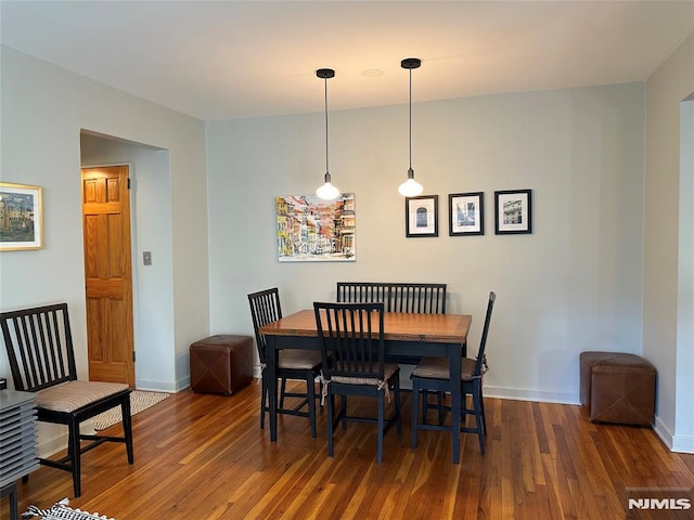 dining space with dark hardwood / wood-style floors