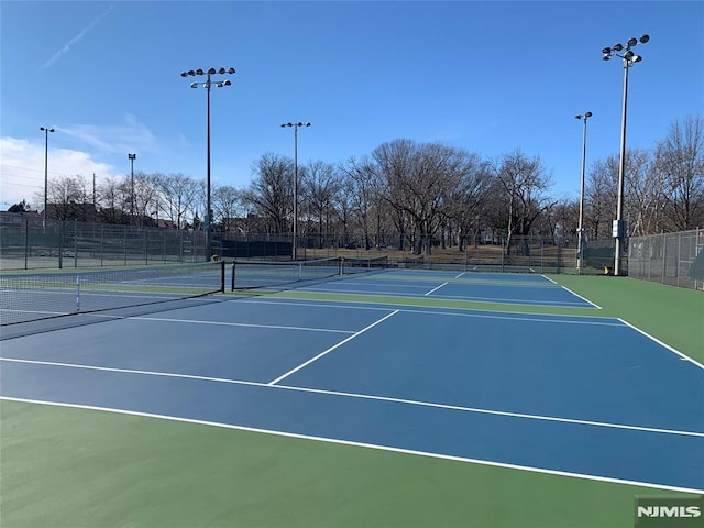 view of tennis court featuring basketball hoop