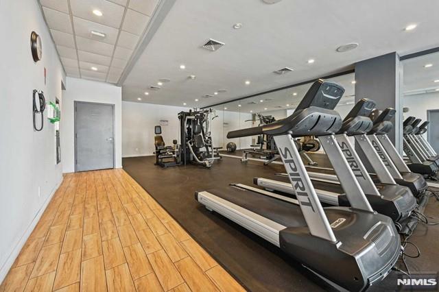 exercise room featuring a paneled ceiling