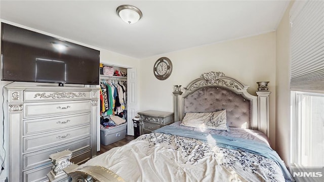 bedroom featuring dark hardwood / wood-style floors and a closet