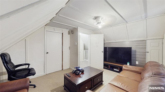 living room with light carpet, vaulted ceiling, and ceiling fan