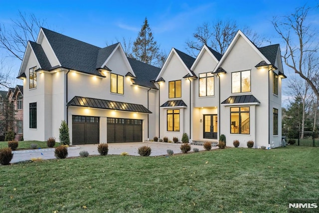 view of front of home featuring a garage and a yard