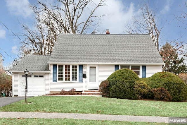 view of front of house with a garage and a front lawn