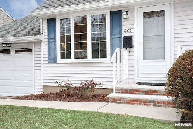 view of exterior entry with a garage