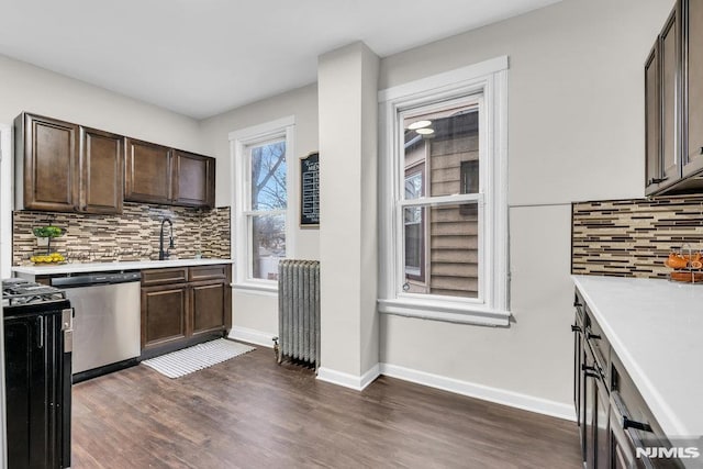 kitchen featuring backsplash, radiator, dishwasher, and range