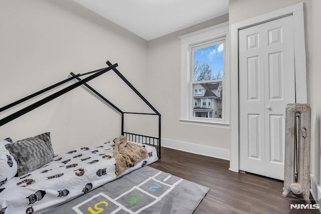 bedroom featuring a closet and dark hardwood / wood-style flooring