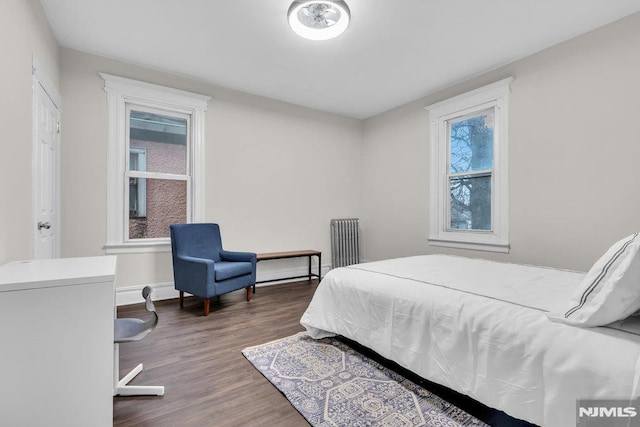 bedroom featuring dark hardwood / wood-style floors and radiator heating unit