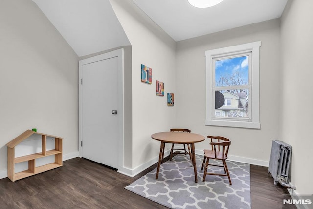 interior space featuring radiator heating unit and dark wood-type flooring