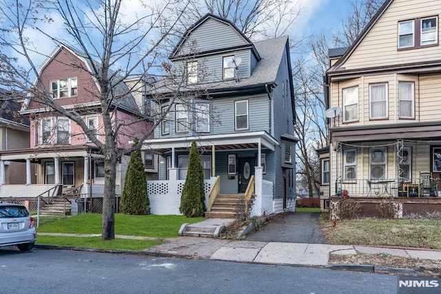 front of property with a porch and a front lawn