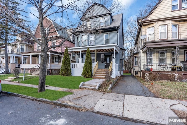 view of front of home featuring covered porch and a front yard