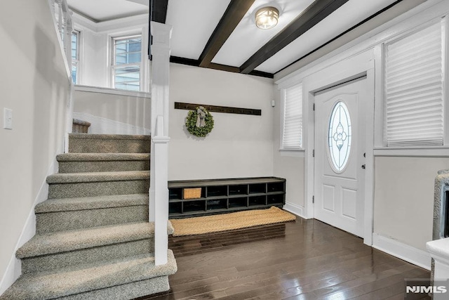 entrance foyer featuring beamed ceiling and dark hardwood / wood-style floors