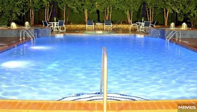 view of pool with pool water feature