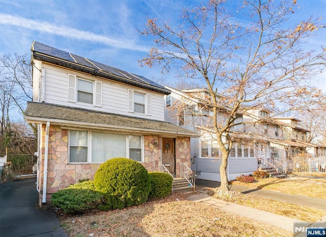 view of front property featuring solar panels