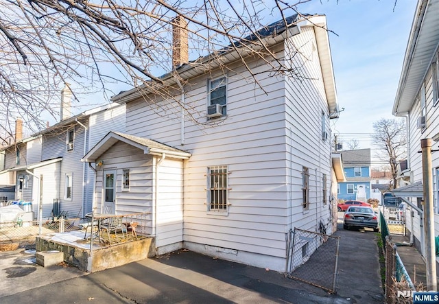 view of front of house featuring cooling unit