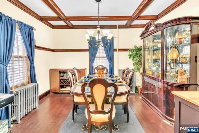 dining area featuring hardwood / wood-style floors, radiator heating unit, coffered ceiling, and an inviting chandelier