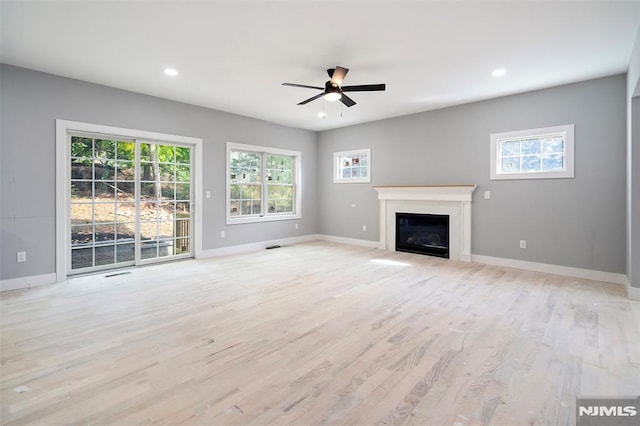 unfurnished living room with ceiling fan and light hardwood / wood-style floors