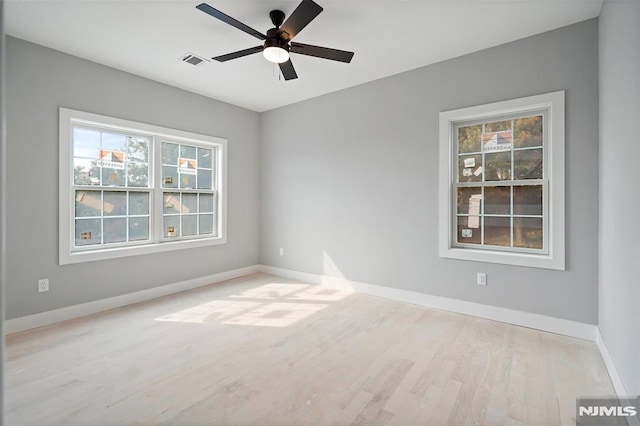 spare room with light wood-type flooring and ceiling fan