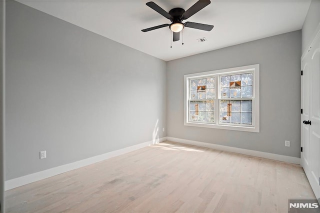 empty room featuring light wood-type flooring and ceiling fan