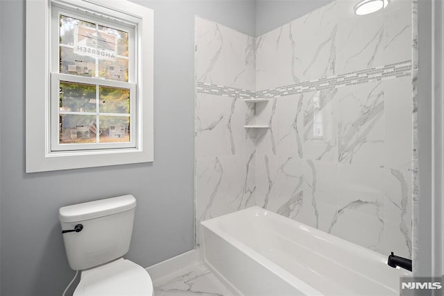 bathroom featuring tiled shower / bath combo and toilet