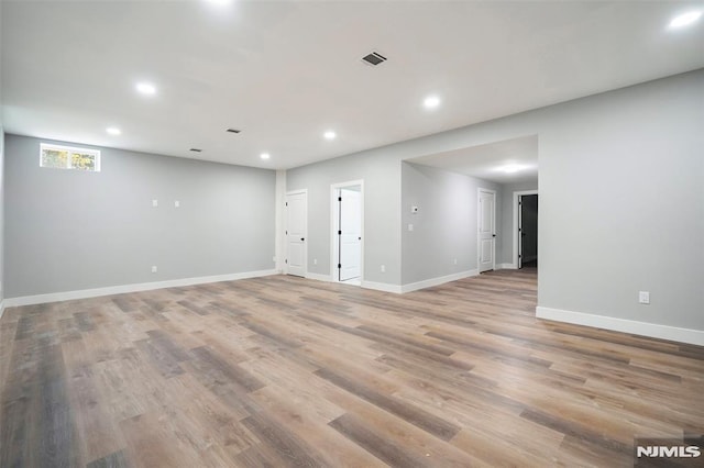 empty room with light hardwood / wood-style flooring