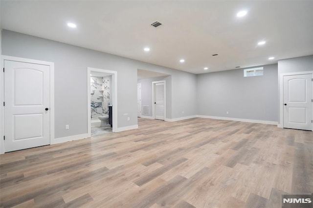 basement with light hardwood / wood-style floors