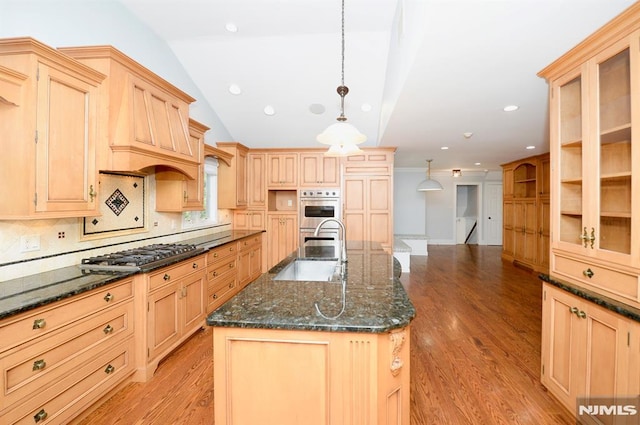 kitchen with pendant lighting, a center island with sink, light brown cabinets, appliances with stainless steel finishes, and sink