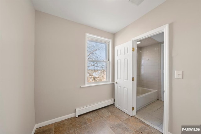 bathroom featuring tiled shower / bath and a baseboard heating unit