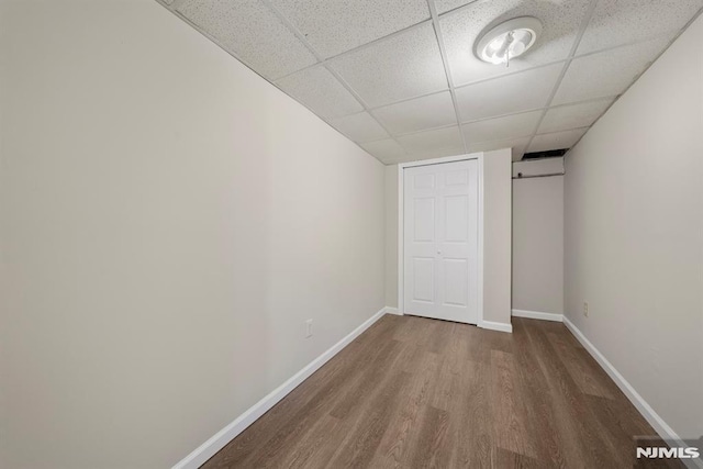 unfurnished bedroom featuring a paneled ceiling and hardwood / wood-style floors